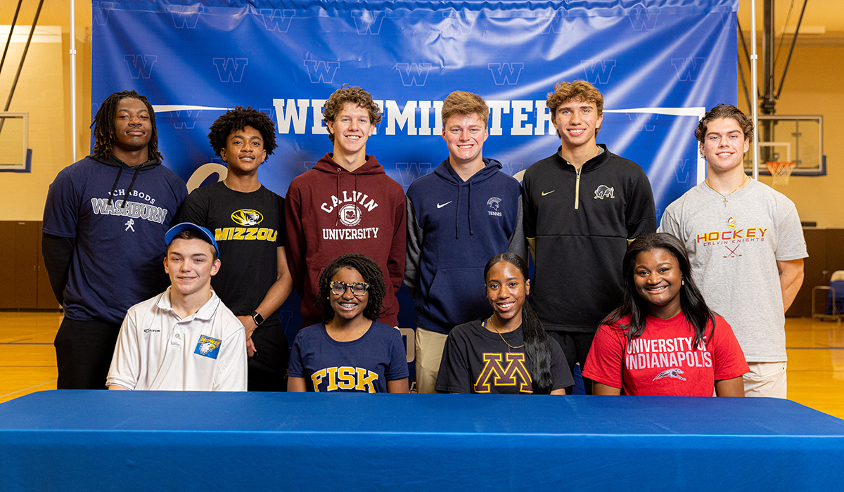 Students sit after signing letters of intent